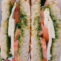 Caprese Sandwich · Tomato, fresh mozzarella and pesto on rustic country bread. Served with a green salad.