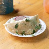 Dilla · Our version of an empanada. Filling of your choice smothered in a drunken sauce and Cotija c...