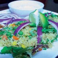 Vegetable Biryani · Basmati rice cooked with sauteed mixed vegetables, herbs and spices. Served with homemade yo...