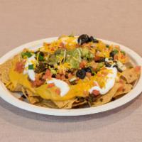 Bandito Nachos · Corn chips with your choice of cheese, choice of bean, tomatoes, green onions, sour cream, o...