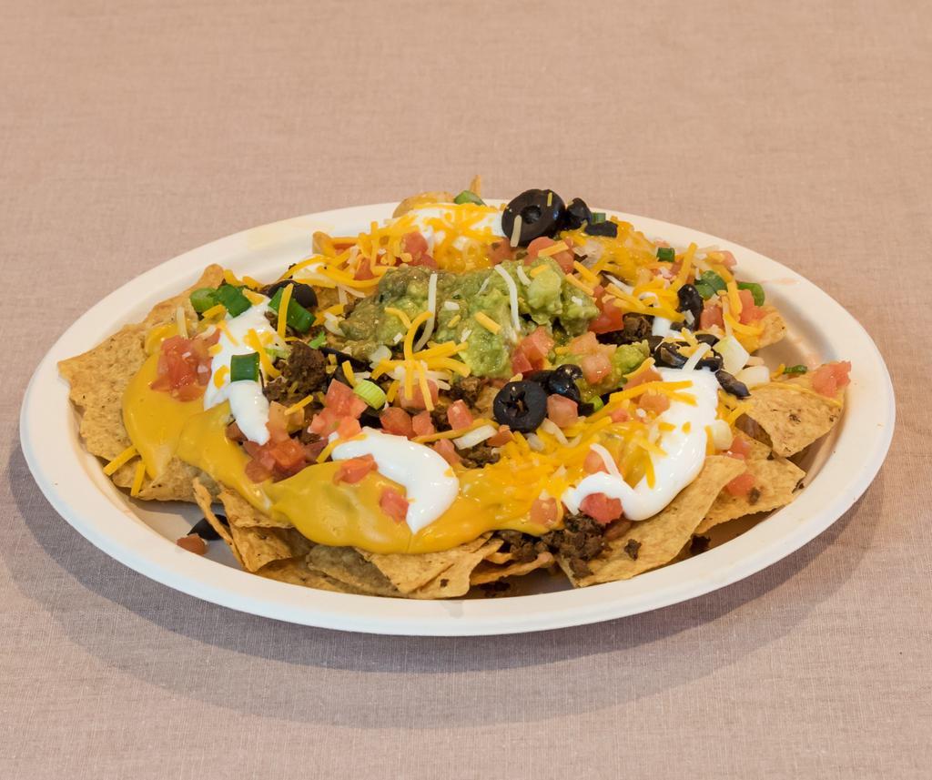 Bandito Nachos · Corn chips with your choice of cheese, choice of bean, tomatoes, green onions, sour cream, olives, fresh homemade guacamole and choice of meat.