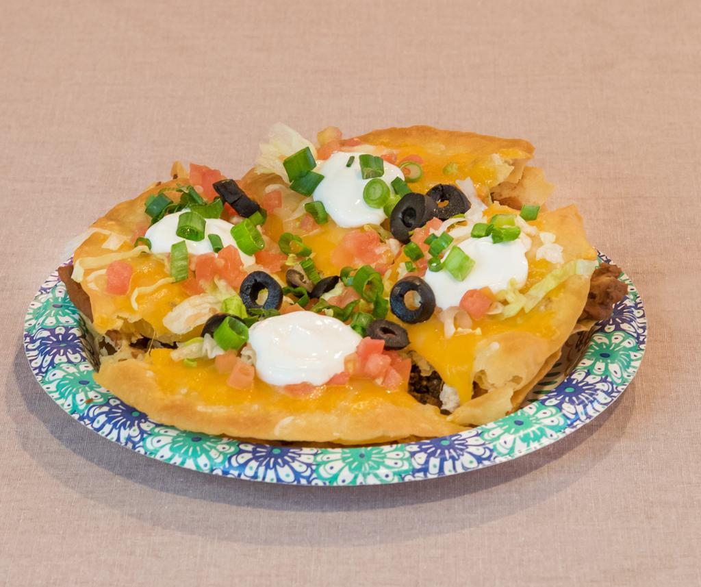 Pizza · 2 crispy flour tortillas. First layer with vegetarian refried beans and your choice of protein. The second layer is topped with melted cheddar cheese, lettuce, tomatoes, green onions, olives and sour cream.