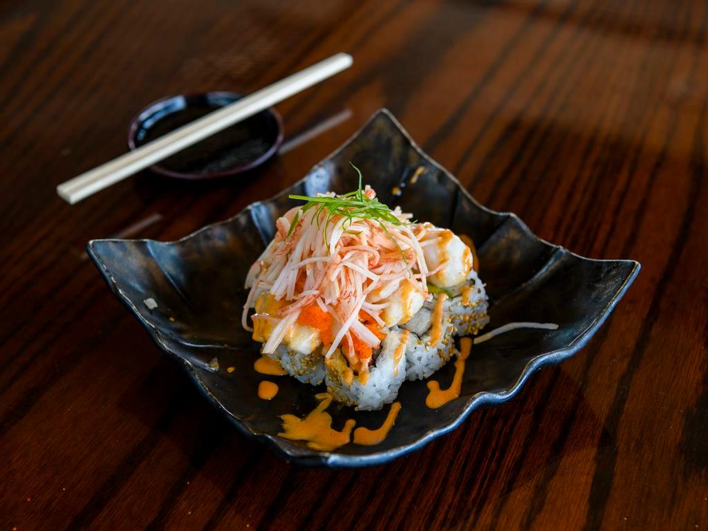 Volcano Roll · Crab, avocado and cucumber, topped with baked scallop, green onion, masago and spicy mayo.