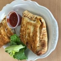 Calzone · Includes 2 kinds of meats and 2 veggies with red sauce, mozzarella cheese, 1/2 cheddar and r...