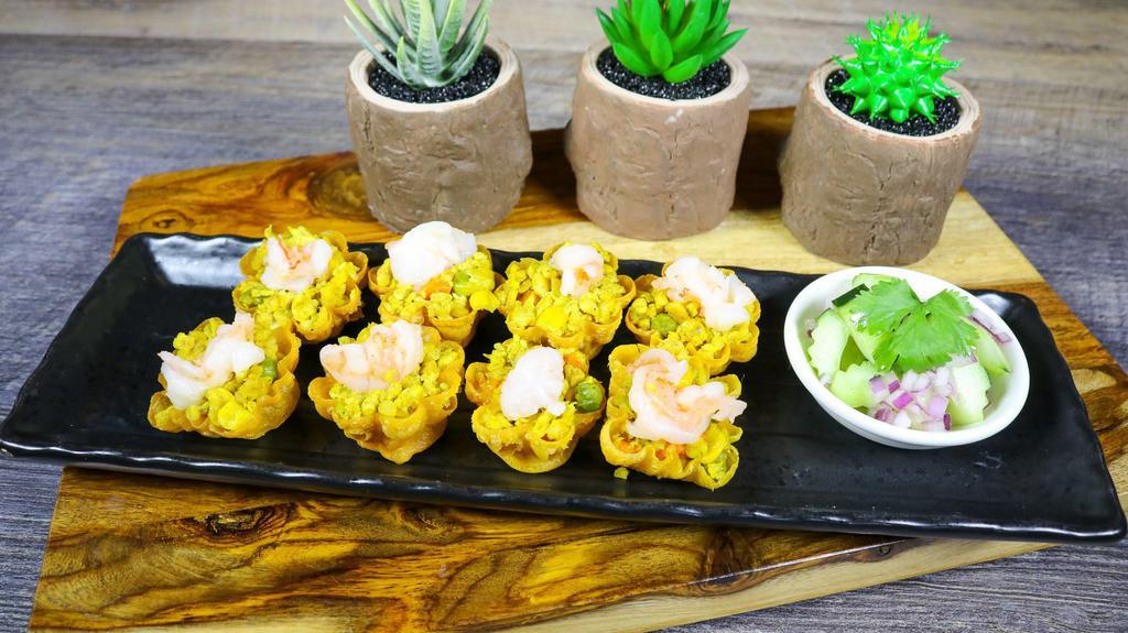 Golden Cup · Minced chicken, shrimp, peas and carrots with a touch of curry powder in a pastry cup served with cucumber salad.