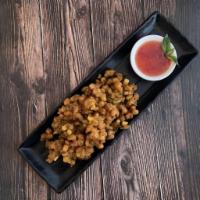 Thai Corn Fritter · Lightly battered corn with Thai spices, basil leaf and kaffir lime leaf served with sweet ch...