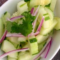 Cucumber Salad · Sliced cucumber topped with chopped onions and bell peppers in vinaigrette dressing.