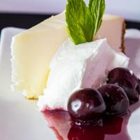 Vanilla Bean Cheesecake · graham cracker crust and fresh fruit coulis