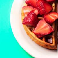 Aunt Miriam's Waffle · Topped with strawberries and maple syrup. Vegan.