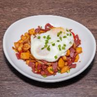Corned Beef Hash · Cubed corned beef tossed in potatoes, onions, peppers served with two eggs.