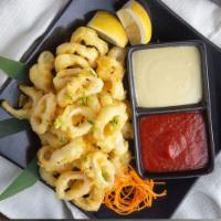 Crispy Calamari · Our famous calamari tempura dipped and served with wasabi aioli and sweet cocktail sauce.