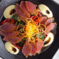 Seared Tuna Tataki · Fresh spicy seared tuna sashimi on warm greens, served with wasabi aioli and ponzu sauce.