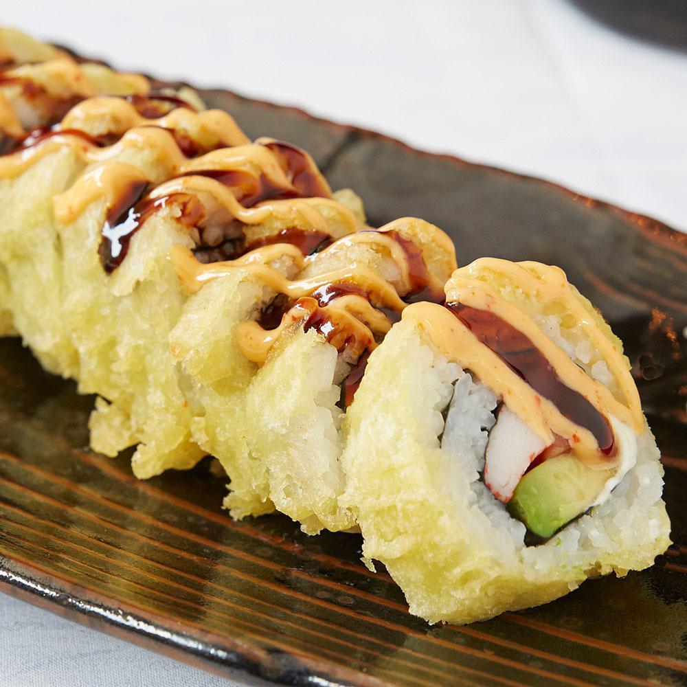 Vegas Roll · Salmon, crab, avocado and cream cheese, tempura dipped, topped with Sumo sauce and sweet sauce.