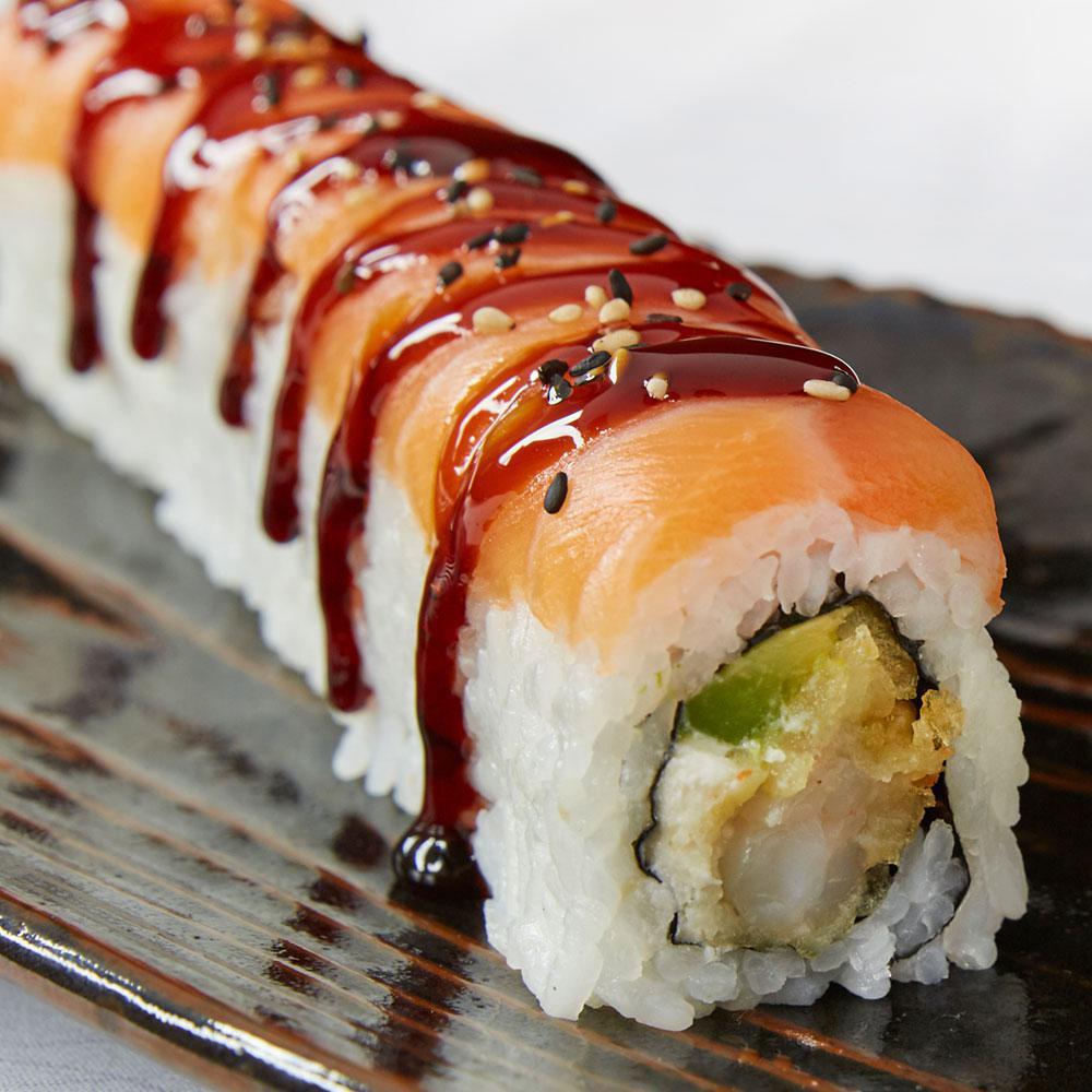 Samurai Roll · Tempura shrimp, avocado and cream cheese topped with salmon sashimi, sweet sauce and sesame seeds.