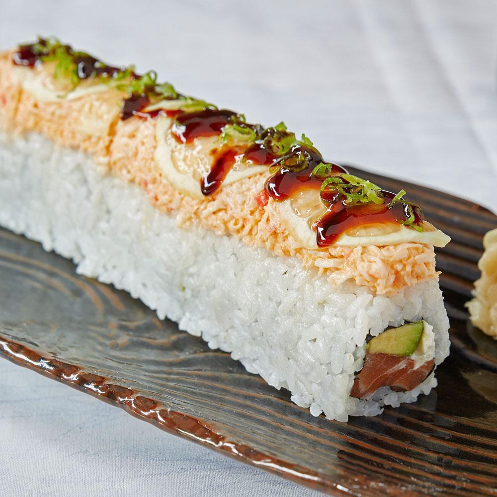 Rising Sun Roll · Salmon, avocado and cream cheese topped with spicy crab salad, green onions, lemon and sweet sauce.