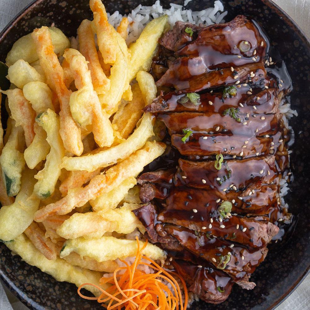 Teriyaki Beef Bowl · Grade A beef strips and our delicious teriyaki sauce served with tempura vegetables and steamed rice.