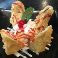 OMG Cheesecake · A decadent slice of cheesecake tempura dipped and topped with caramel and raspberry sauce se...