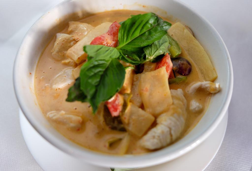 Red Curry · Authentic Thai Red Curry in Home Made Style with eggplants, bamboo shoots, string beans, bell peppers & basil leaves with a coconut milk. Served with Rice