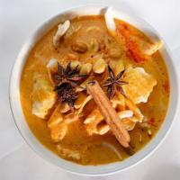 Massaman Curry · Pearl onion, peanut, lotus seeds & grilled potatoes with coconut milk. Served with Rice. Spi...