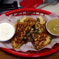 philly cheese steak quesadilla · philly steak, grilled onion, cheese, mexican slaw, garnished w/cilantro.