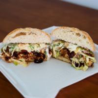 Pulled Pork Sandwich · Homemade cola pulled pork topped with a garden slaw and BBQ sauce on a bun.
