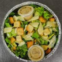 Caesar Salad · Romaine lettuce and shaved Parmesan with croutons and Caesar dressing on the side.