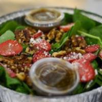 Spinach Salad · Fresh spinach topped with crumbled goat cheese, walnuts, and sliced strawberries. Served wit...
