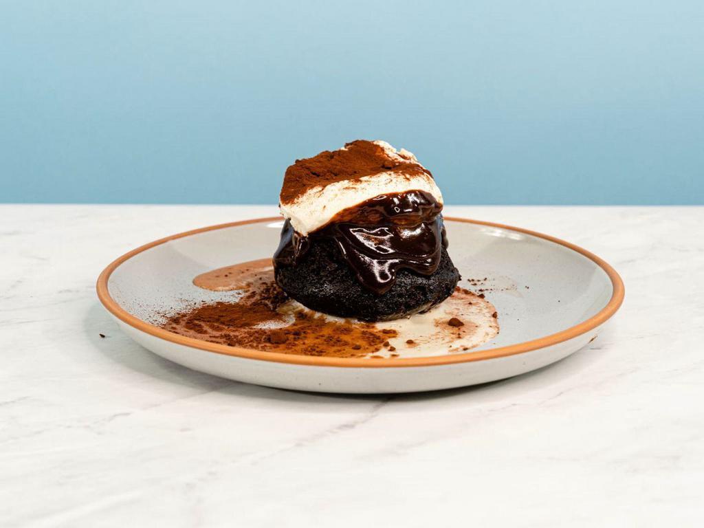 Chocolatey Uno Mas Leche Cake · Our tres leches needed one more milk! Enjoy this EVOO devil's food cake, soaked to fudgy perfection. This decadent cake is topped with a smooth honey-chocolate glaze, a dollop of whipped creme fraiche and chocolate shavings | Allergen: Milk, Egg