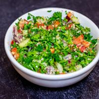 Taboli Salad · Bulgar mixed with parsley, onions, fresh tomatoes, cucumbers and dressed with freshly squeez...