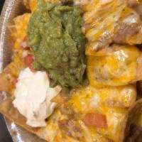 Super Nachos (no meat) · Nachos topped with beans, guacamole, sour cream, tomatoes, onions, and cheddar cheese.