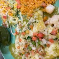 Enchiladas de Mariscos · Shrimp and scallops sautéed with tomatoes wrapped In a corn tortillas topped with green sals...