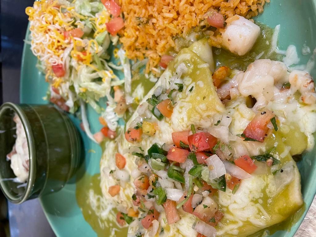 Enchiladas de Mariscos · Shrimp and scallops sautéed with tomatoes wrapped In a corn tortillas topped with green salsa served with whole pinto beans and rice