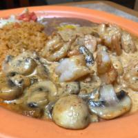 Camarones al Chipotle · Shrimp sauteed with mushrooms, in a creamy chipotle sauce. Served with rice and beans.
