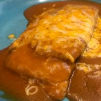 One Piece Tamal · Shredded pork filled tamale topped with sauce and cheese 