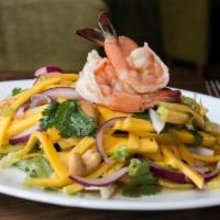 Mango Salad · Mango, shrimp, peanut, red onion and lime chili sauce on a bed of lettuce.