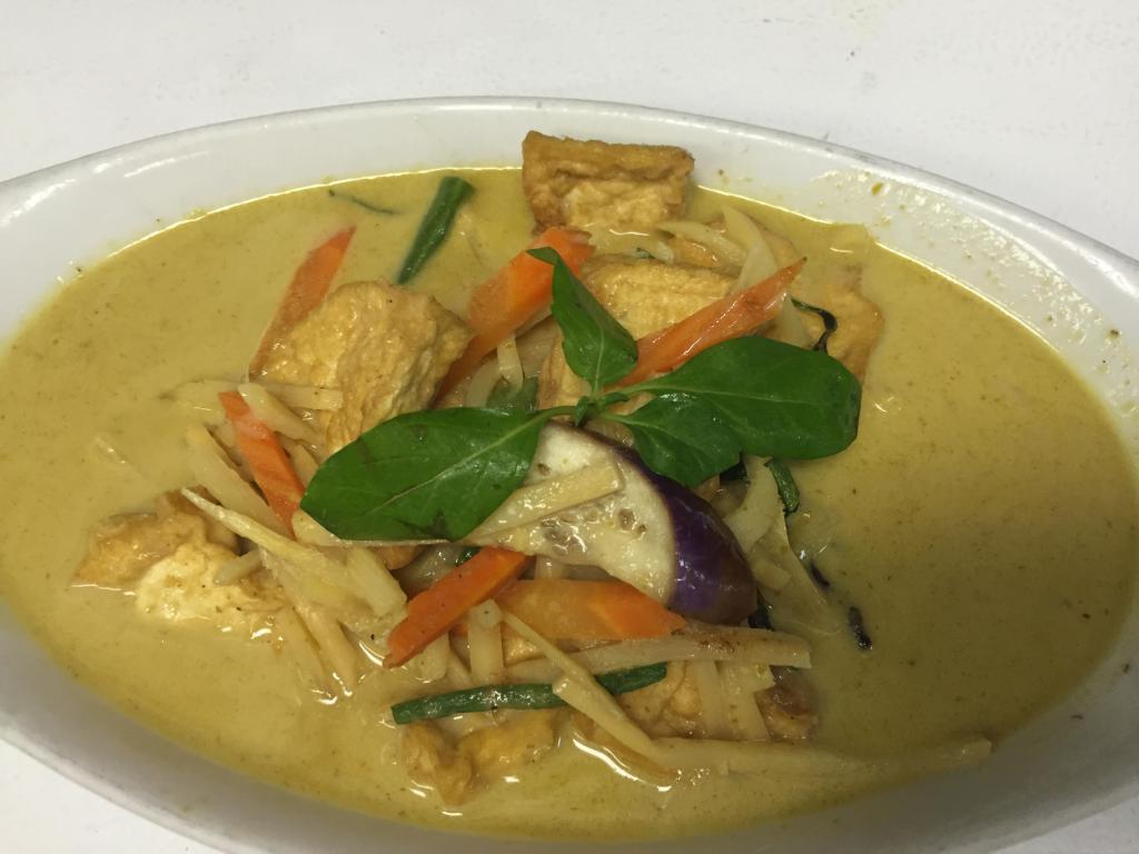 Green Curry · Green curry, coconut milk, eggplant, bamboo shoot, basil and bell pepper. Spicy.