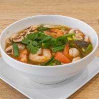 Tom Yum Soup · Thai hot and sour soup with mushroom, green onions, lemongrass, kaffir leaf, galanga, and ch...
