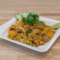 Pineapple Fried Rice · Pineapple, curry powder, raisins, cashews, onion, scallion, egg, with chicken and shrimp