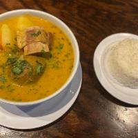 Caldo de Bola · Beef stuffed plantain soup, cassava, vegetales served w/ rice