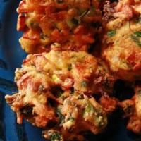 Vegetable Pakoras · Mixed vegetables dipped in gram flour and fried to perfection.