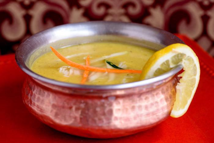 Mulligatawny · Lentil soup with spices. Garnished with julienne vegetables, rice and lemon.