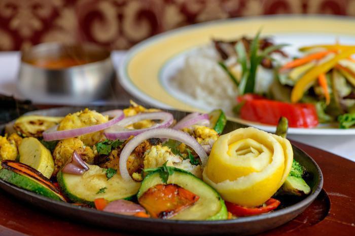 Fish Tikka · Chunks of fresh fish marinated in yogurt and herbs, cooked in a clay oven. Served with vegetables and rice.