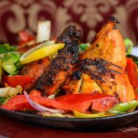 Tandoori Chicken · Spring chicken marinated in special marinade with freshly ground spices. Cooked in a clay ov...