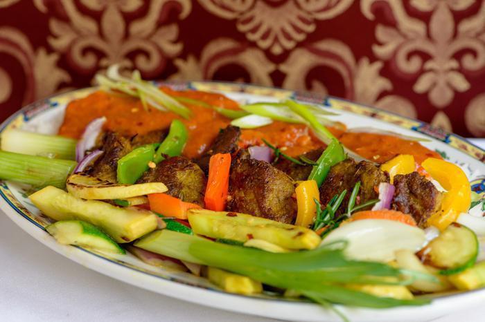 Lamb Kebab · Chunks of lamb on a stick, cooked in a clay oven. Served with vegetables and rice.