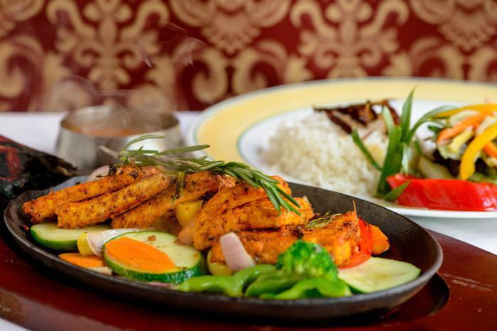 Tandoori Tofu · Marinated tofu grilled to perfection and cooked in a clay oven. Served with vegetables and rice.