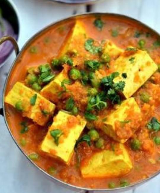 Mattar Paneer · Homemade cheese and peas cooked with tomatoes, herbs and spices. Served with saffron basmati rice pilaf.