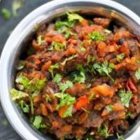 Began-Bhurta · Roasted eggplant cooked with fresh tomatoes, onions, herbs and spices. Served with saffron b...