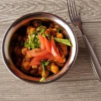 Vegan Chana Masala · Chickpeas cooked with tomatoes in a special sauce. Vegan.