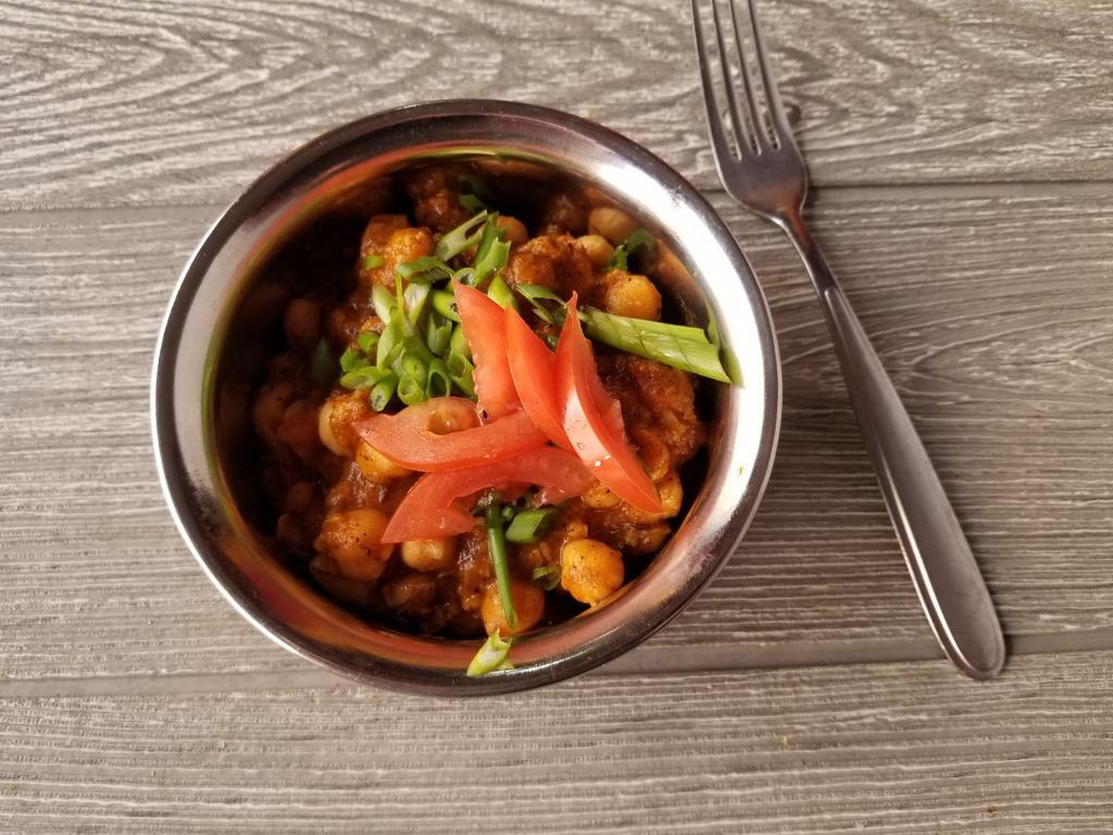 Vegan Chana Masala · Chickpeas cooked with tomatoes in a special sauce. Vegan.