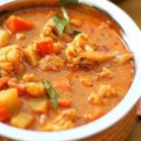 Vegetable Curry · Fresh vegetables cooked in a blend of onions, tomatoes and garlic. Served with saffron basma...